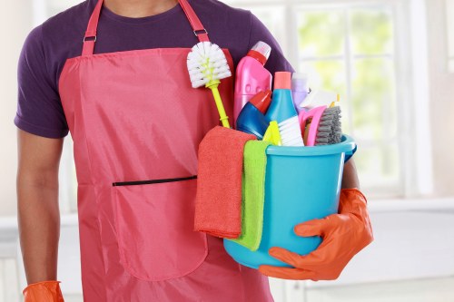 Technician using professional carpet cleaning machine safely