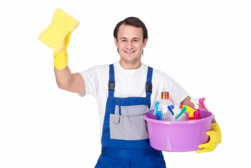 Cleaner wearing PPE during carpet cleaning work